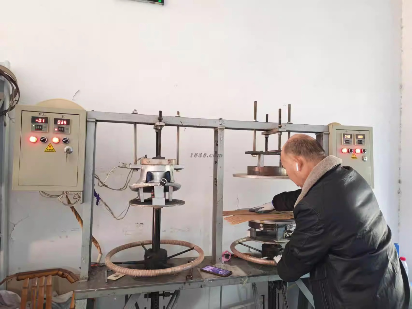 Worker operating a hat shaping machine